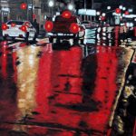 a white car and a red truck stand waiting for traffic lights on a downtown Peterborough street; the wet pavement reflects red and orange lights