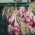 red onions hanging to dry on a barn door