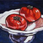 Two large red tomatoes on a white platter against a blue/purple background